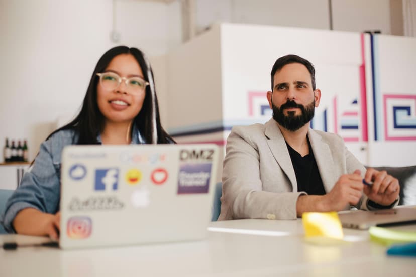 Two people looking at a laptop